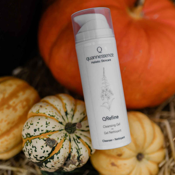 Skincare product with pumpkins in the background. Quannessence Skincare, professional skincare, Holistic Beauty, Made in Canada, Naturally Sourced, Active ingredients, women-owned, Face, Cleanser, Gel, QRefine, Gentle Gel Cleanser, white container with pump