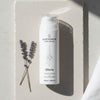 Skincare cream bottle labeled 'quannessence' with lavender on a textured surface. Quannessence Skincare, professional skincare, Holistic Beauty, Made in Canada, Naturally Sourced, Active ingredients, women-owned, Face, Cleanser, Cream, QRevive, Facial Cleansing Cream, white container with pump
