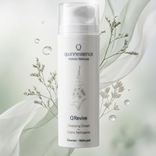 Quannessence QRevive Cleansing Cream bottle with floral elements on a light background. Quannessence Skincare, professional skincare, Holistic Beauty, Made in Canada, Naturally Sourced, Active ingredients, women-owned, Face, Cleanser, Cream, QRevive, Facial Cleansing Cream, white container with pump