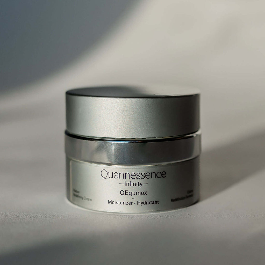 Skincare jar labeled 'Quannessence' on a neutral background.Quannessence Skincare, Infinity Collection, professional skincare, Holistic Beauty, Made in Canada, Naturally Sourced, Active ingredients, women-owned, Face, Moisturizer, Equinox, Equinox Age Renewal Cream, Silver packaging jar with silver lid