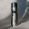 Skincare serum bottle labeled 'quannessence' on a neutral background. Quannessence Skincare, Infinity Collection, professional skincare, Holistic Beauty, Made in Canada, Naturally Sourced, Active ingredients, women-owned, Face, Serums, Qazul, Azul Rejuvenating Serum, Silver packaging with silver lid and pump