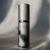 Skincare serum bottle with 'quannessence' branding on a gray background. Quannessence Skincare, Infinity Collection, professional skincare, Holistic Beauty, Made in Canada, Naturally Sourced, Active ingredients, women-owned, Face, Serum, QSolstice, Solstice Redefining Serum, Silver packaging with silver lid and pump