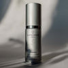Skincare serum bottle labeled 'quannessence' on a neutral background. Quannessence Skincare, Infinity Collection, professional skincare, Holistic Beauty, Made in Canada, Naturally Sourced, Active ingredients, women-owned, Face, Serum, QSolstice, Solstice Redefining Serum, Silver packaging with silver lid and pump