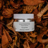 Quannessence skincare product on a bed of dried leaves. Quannessence Skincare, professional skincare, Holistic Beauty, Made in Canada, Naturally Sourced, Active ingredients, women-owned, Face, Moisturizer, Lotion, Cream, QLuminess, Luminess Face Lotion, white jar