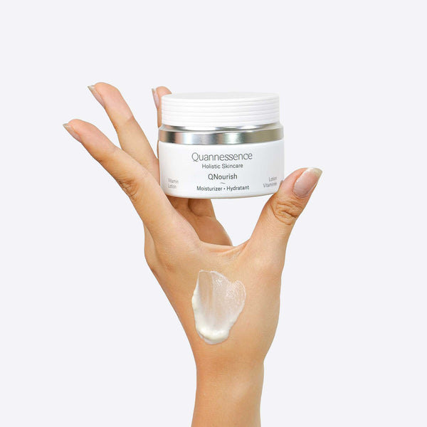 Quannessence Skincare, professional skincare, Holistic Beauty, Made in Canada, Naturally Sourced, Active ingredients, women-owned, Face, Moisturizer, Lotion, Cream, QNourish, uniQue encapsulated Vitamin Lotion, white jar, hand with cream