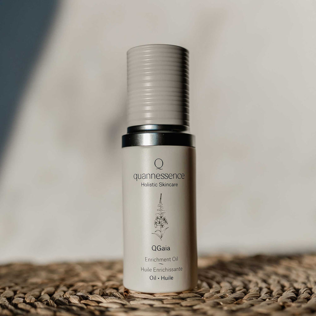 QGaia Enrichment Oil by Quannessence in elegant packaging on a natural background.