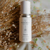 QHyaluron Hydrating Complex by Quannessence, Skincare serum bottle with 'quannessence' branding on a floral background. Quannessence Skincare, professional skincare, Holistic Beauty, Made in Canada, Naturally Sourced, Active ingredients, women-owned, Face, Serum, QHYaluron, Hyaluronic (PUR) Hydrating Serum, white glass packaging with white lid & pump